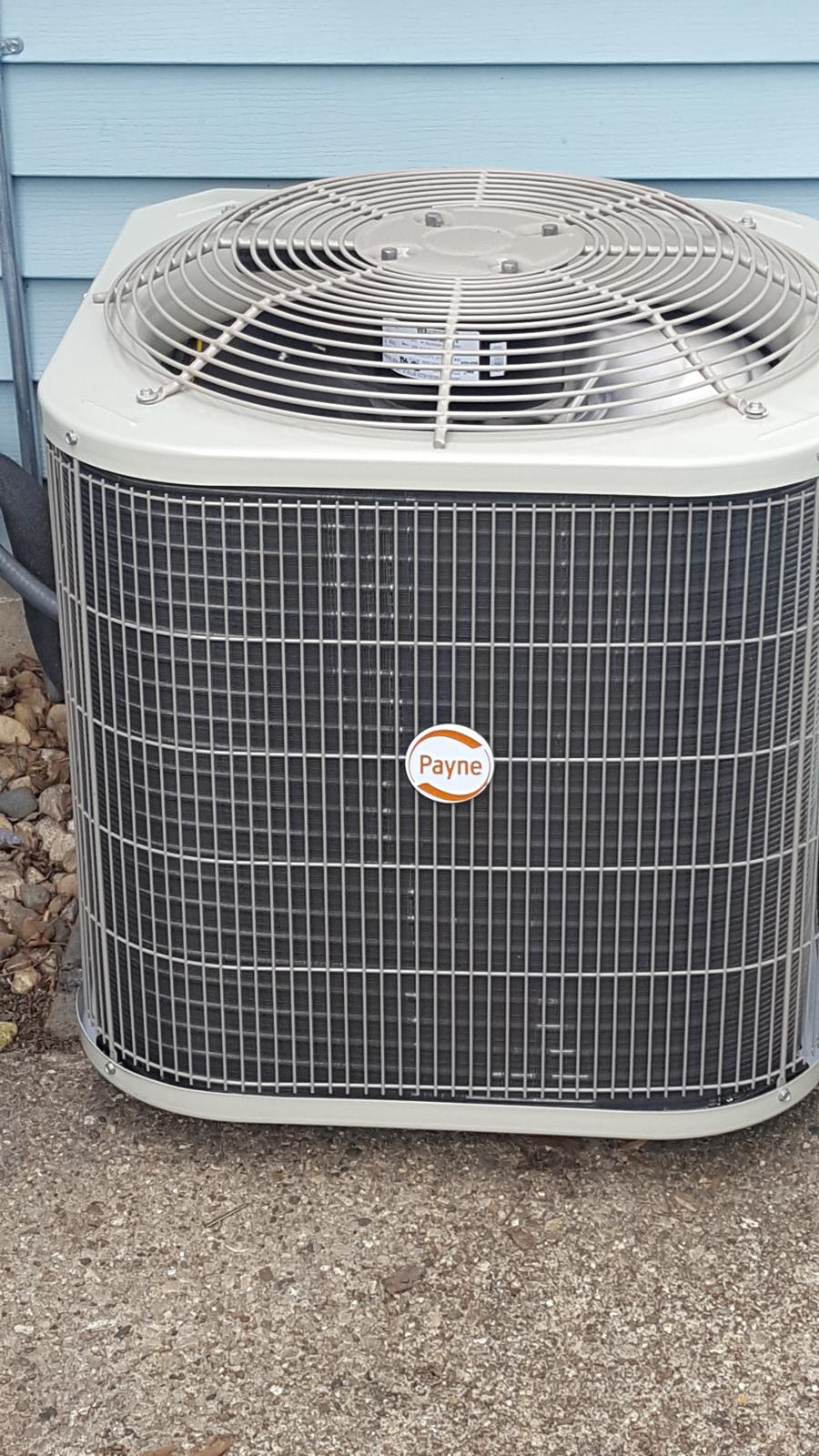 New Payne air conditioning condenser outside a home