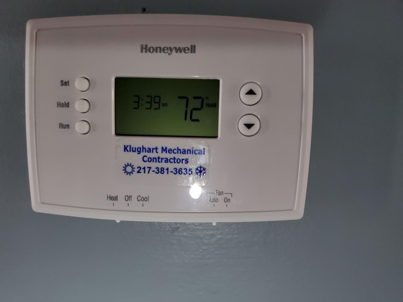 Honeywell thermostat with a Klughart Mechanical Contractors sticker