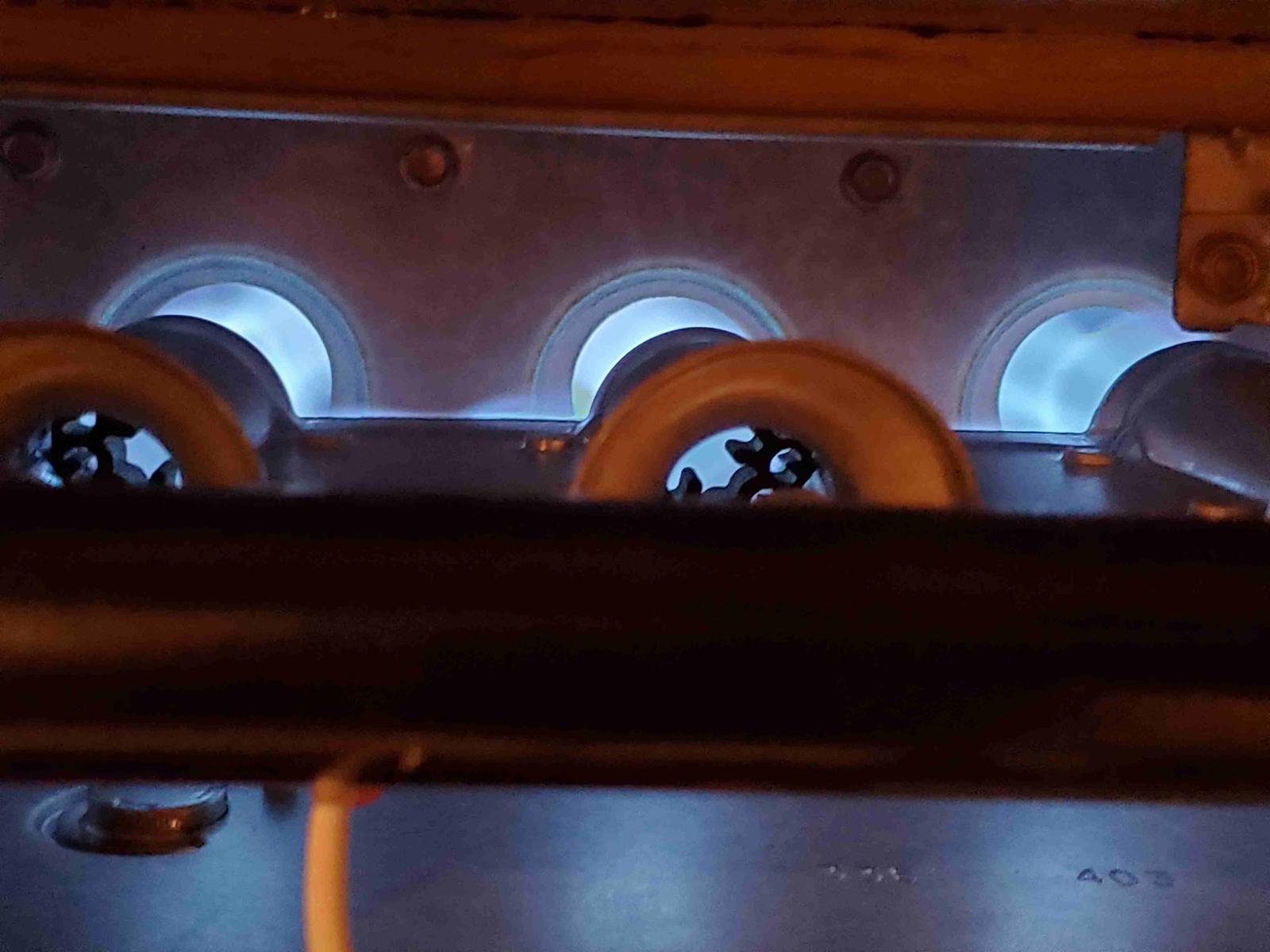 Furnace burners lit with a blue flame