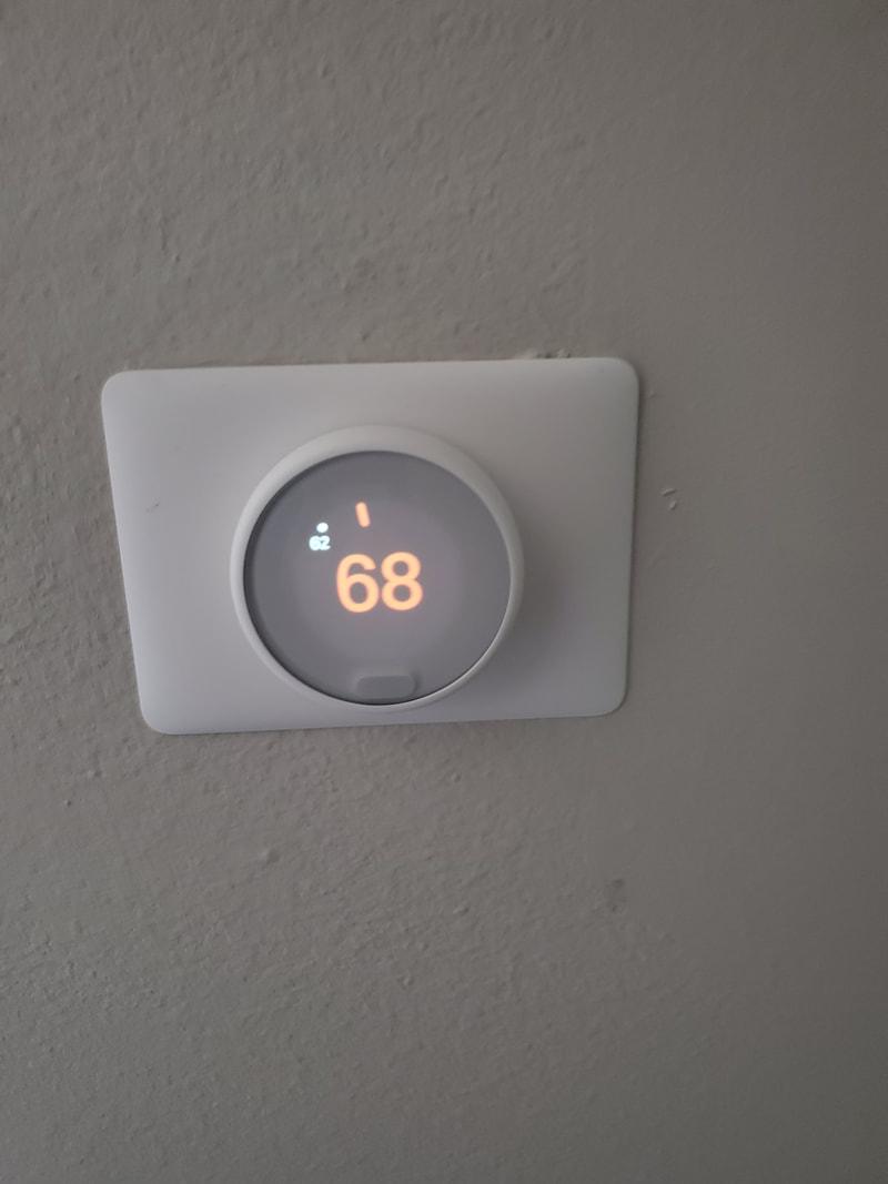 Smart thermostat installed on a wall